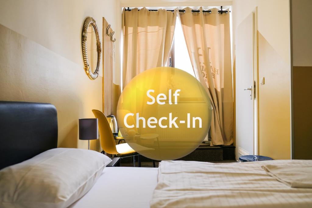 a room with a bed and a self check in sign at Hammerbrook Hostel in Hamburg