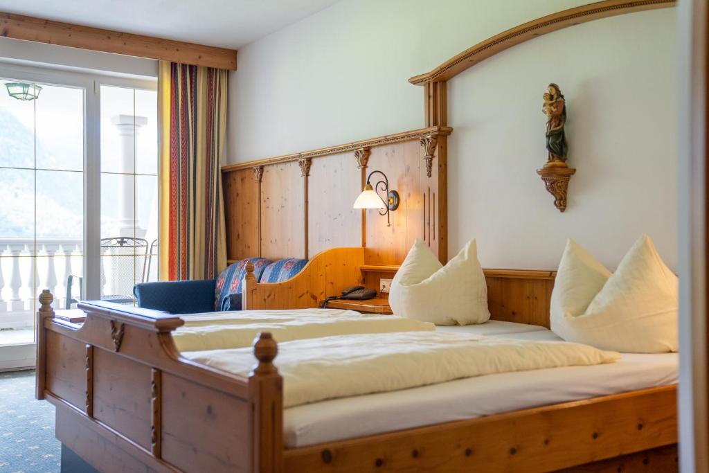 Postel nebo postele na pokoji v ubytování Posthotel Erlerwirt