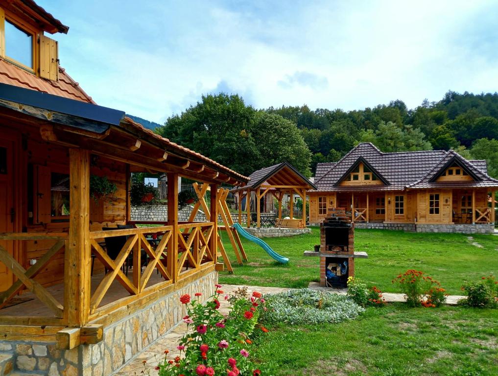 a yard with a playground and a house at Apartment Mateja in Mokra Gora