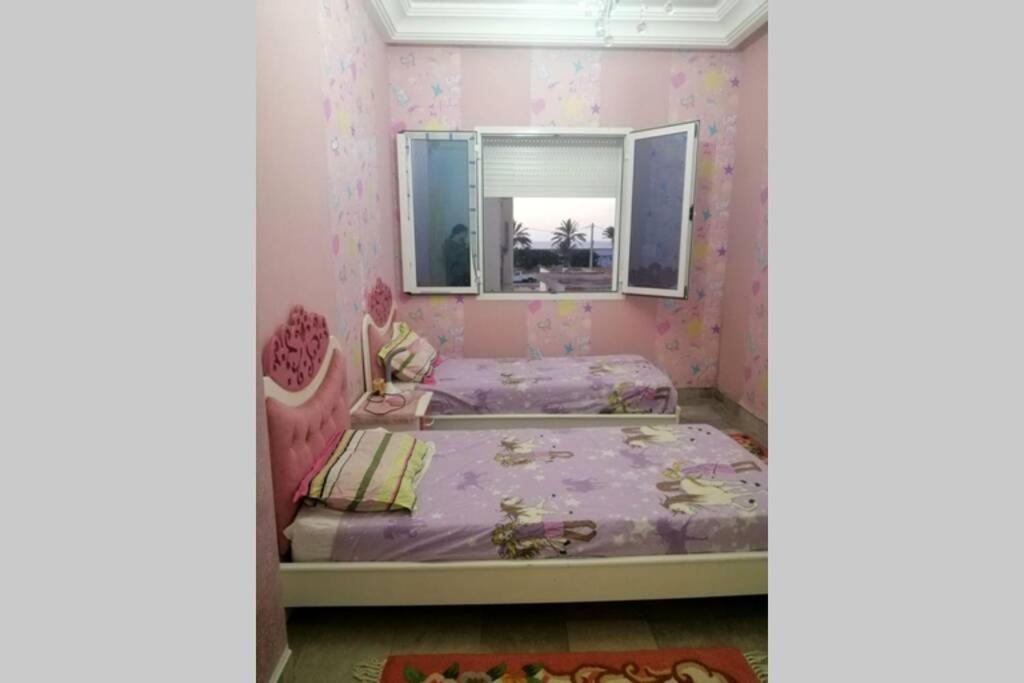 a bedroom with a bed and a mirror at Beautiful appartment with a glorious sea view in Monastir