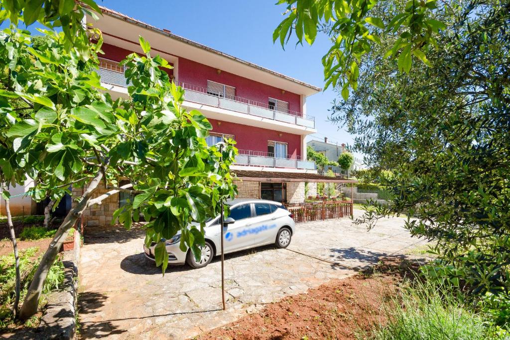 a car parked in front of a building at Apartments Mladen Jelica in Ičići