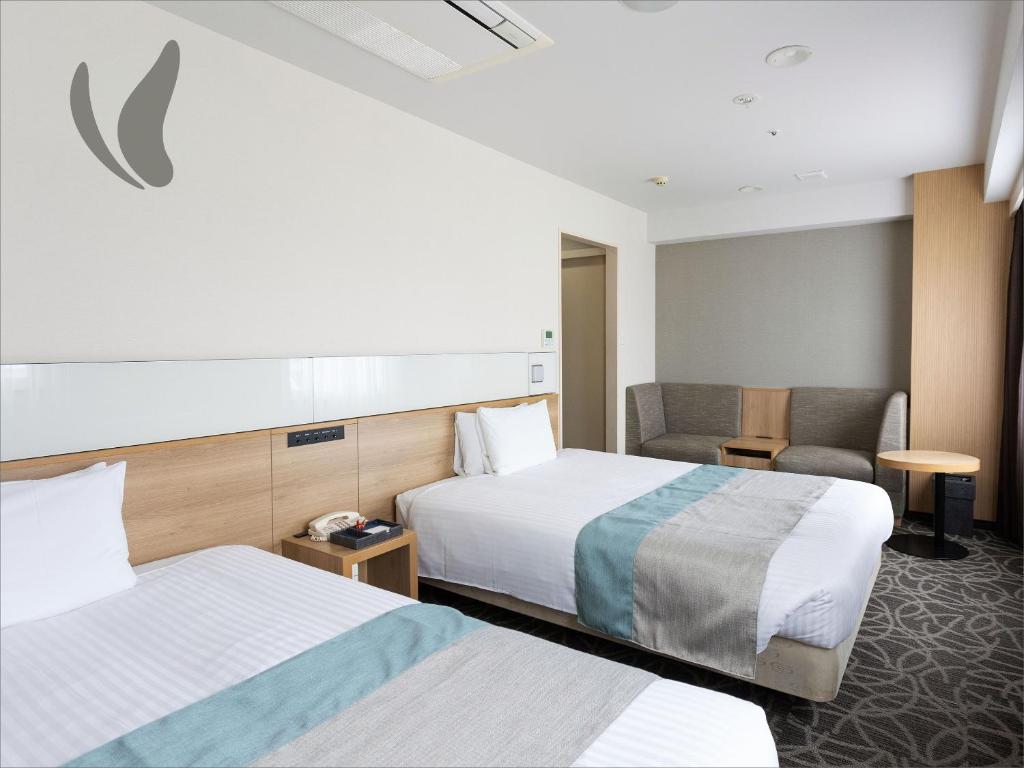 Postel nebo postele na pokoji v ubytování Almont Hotel Naha Omoromachi