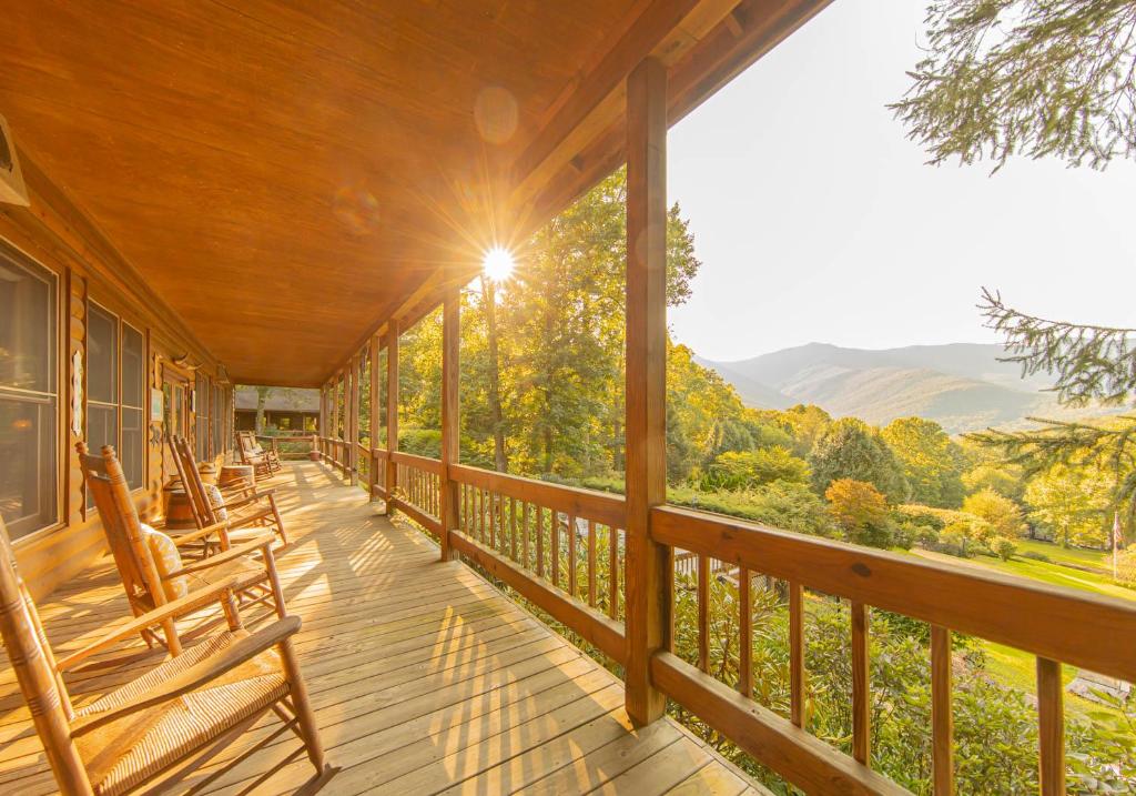 a porch with chairs and a view of the mountains at Mount Mitchell Eco Retreat in Busick