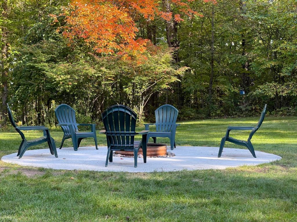drie stoelen rond een tafel in een park bij Anglers Retreat in Crump