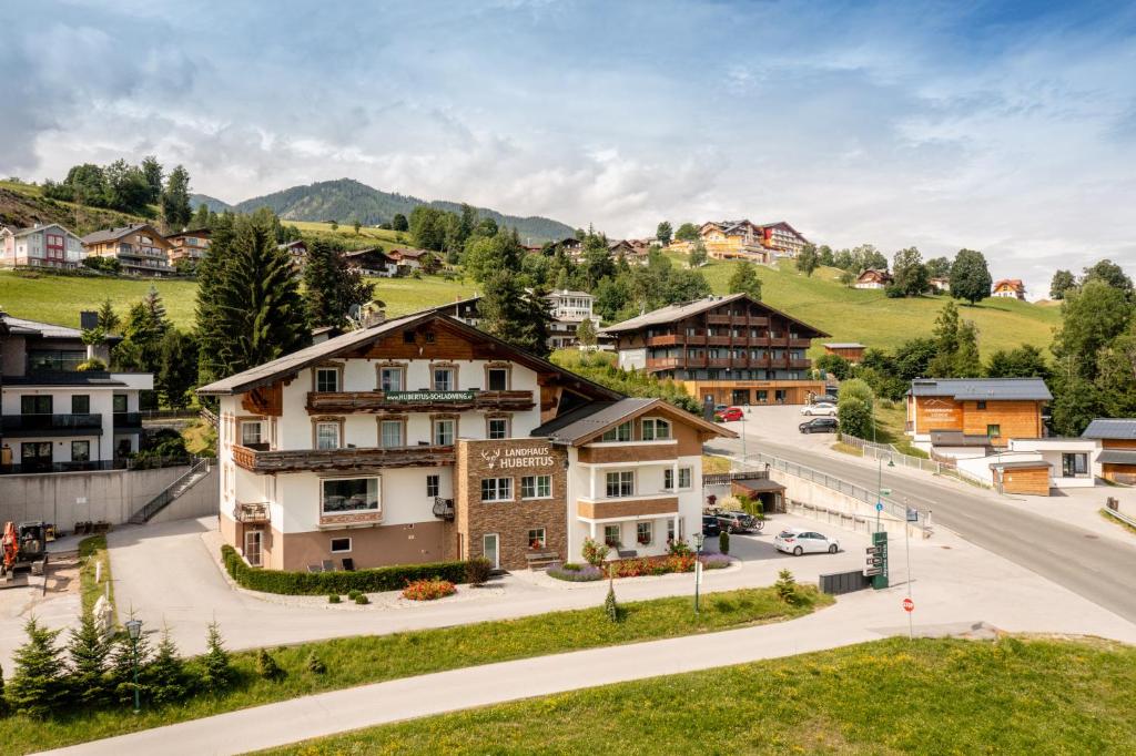 a town in the mountains with a road and buildings at Appartements Landhaus Hubertus Wellness & Breakfast in Schladming