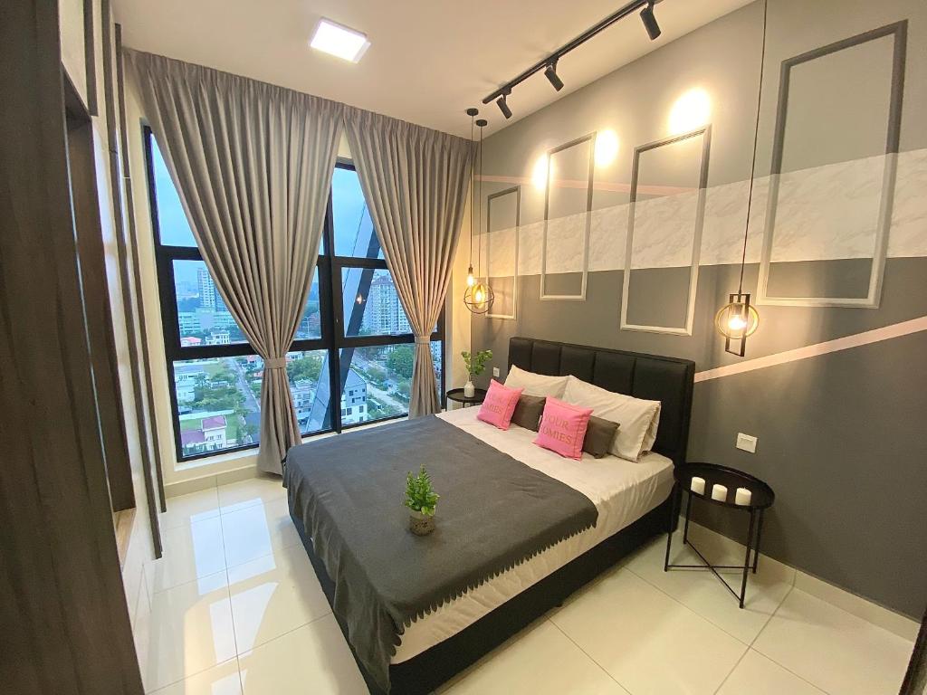 a bedroom with a large bed with pink pillows at 1BR ARTE Mont Kiara WIFI in Kuala Lumpur