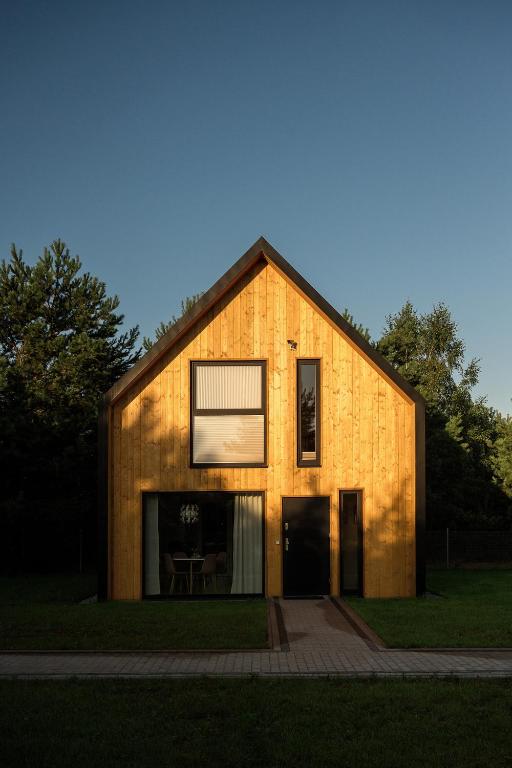 a house with a large window on the side of it at Osada Hygge in Gostynin