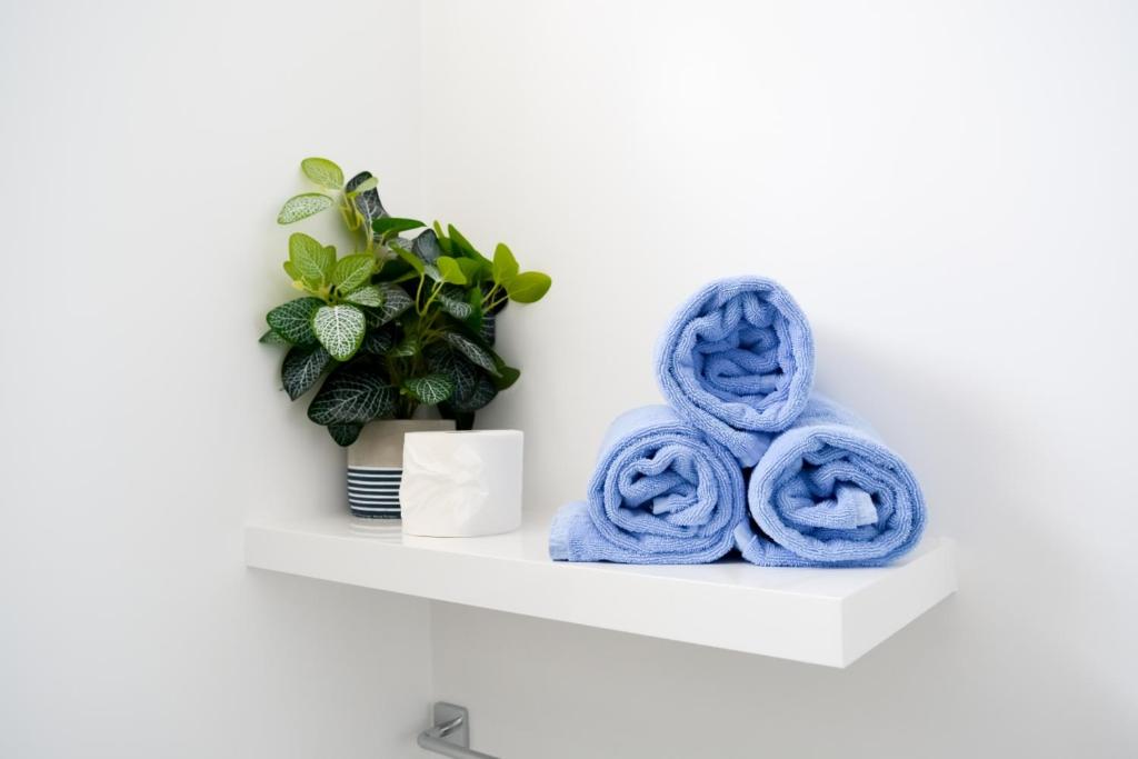 a white shelf with blue towels on it at Island Home Fuerteventura in Corralejo
