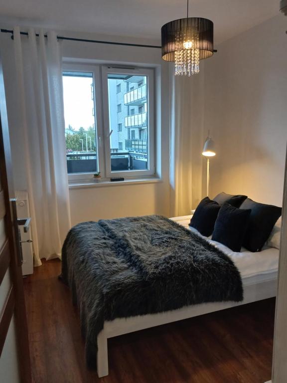 Posteľ alebo postele v izbe v ubytovaní Apartament - malowniczy Augustów