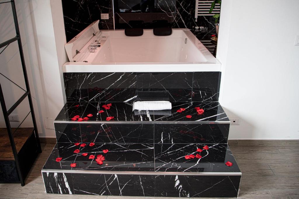 a black and white dresser with red flowers on it at CS LUXURY HOUSE in Lido di Ostia