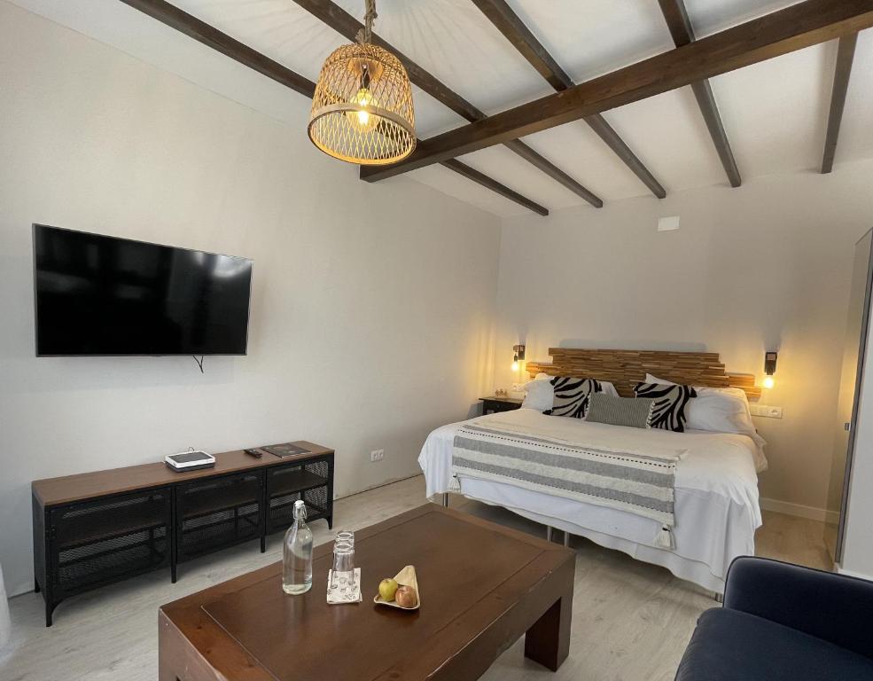 a bedroom with a bed and a flat screen tv at Hotel Villa Bandama Golf - Adults Only in Santa Brígida