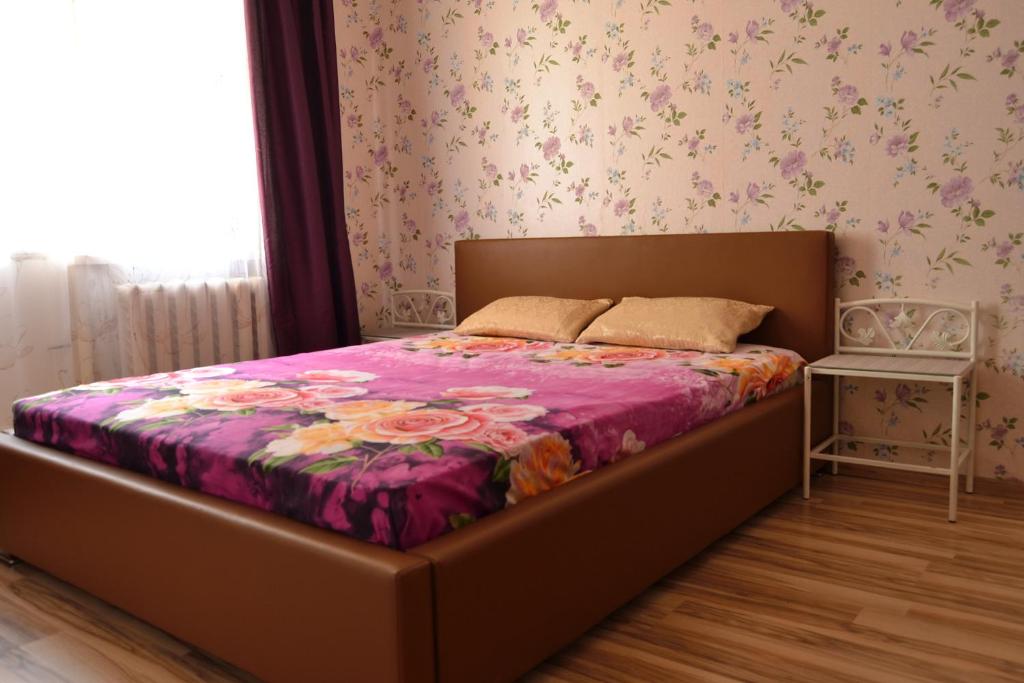 a bedroom with a bed with a purple blanket at Imanta Apartment Riga 2х Rooms 52м2 in Rīga