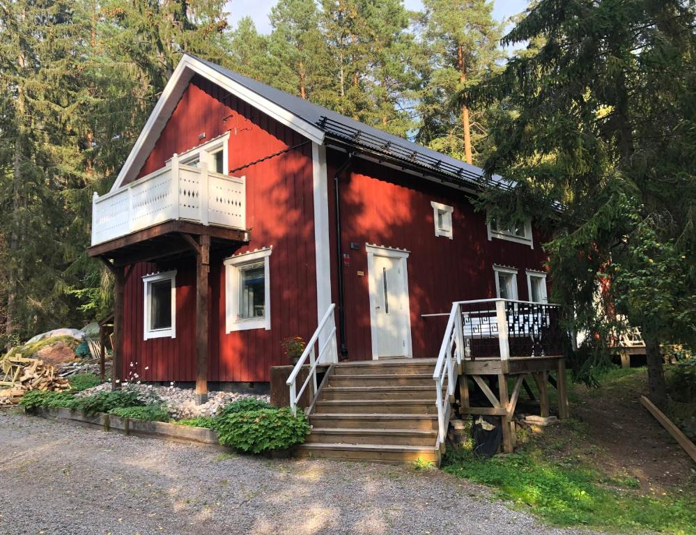 a red house with stairs leading up to it at Granbackens BoB in Falun