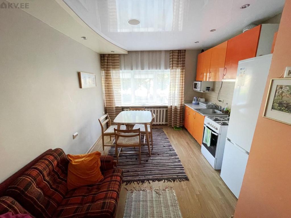 a living room with a couch and a table and a kitchen at Samanta Apartaments in Sillamäe