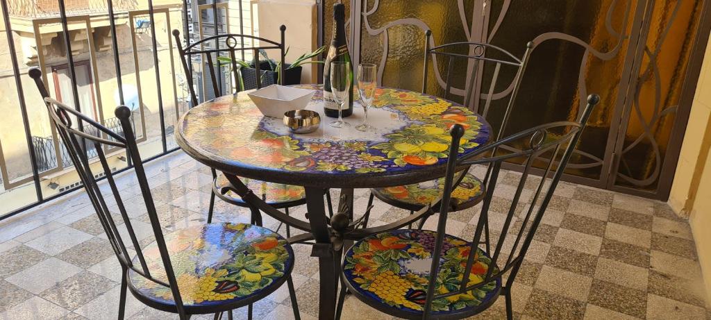 a table with chairs and a table with a colorful table at Ballarò Guest House in Palermo