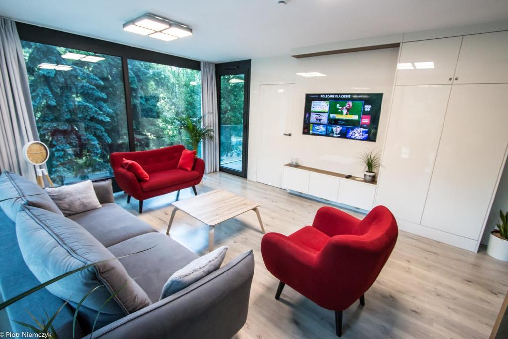 Televízia a/alebo spoločenská miestnosť v ubytovaní Apartament Unia 12 Basen&SPA