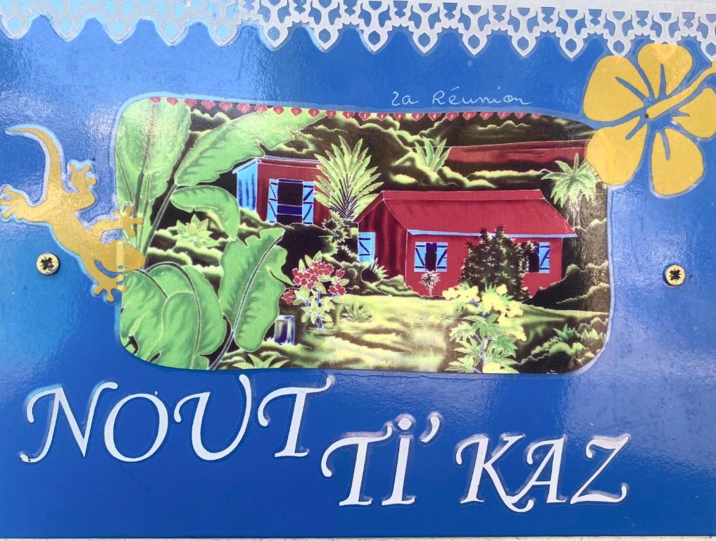 a sign with a picture of a house and plants at NOUT TI KAZ lé bains in L'Étang-Salé les Bains