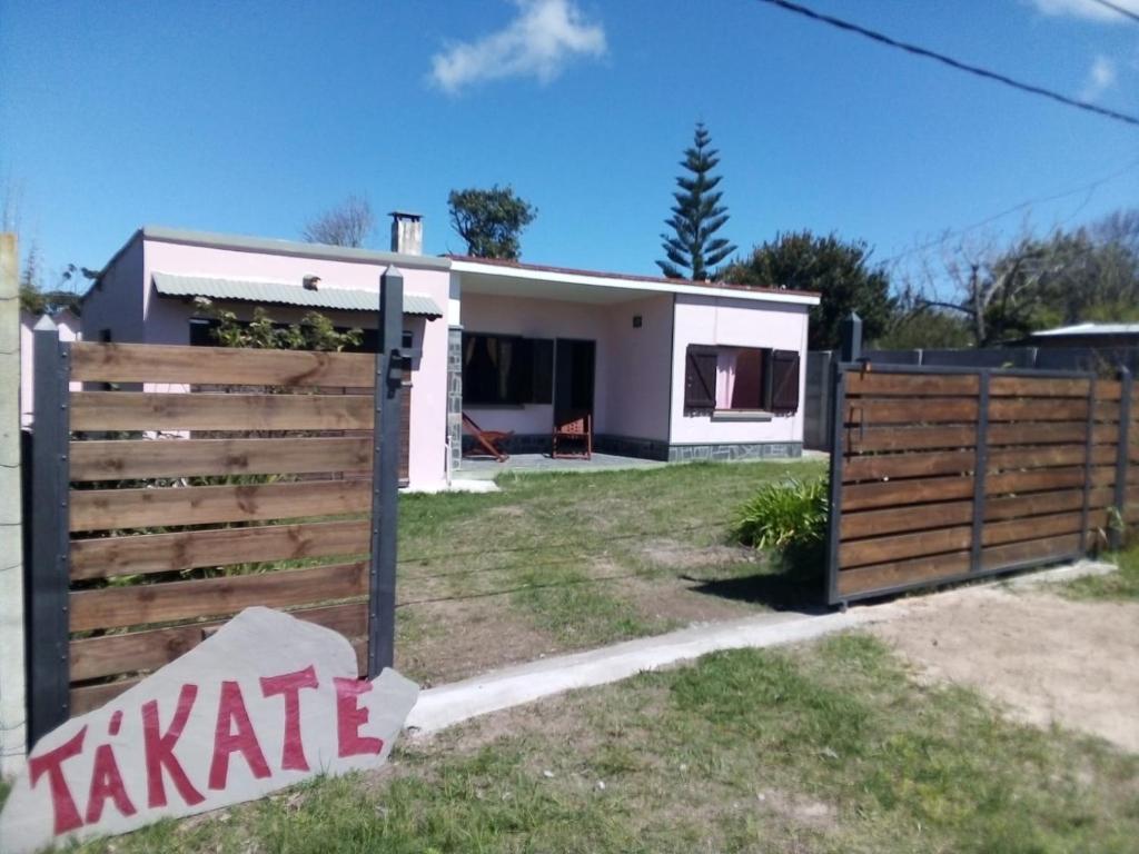 a house with a wooden fence in front of it at Tákate in Costa Azul