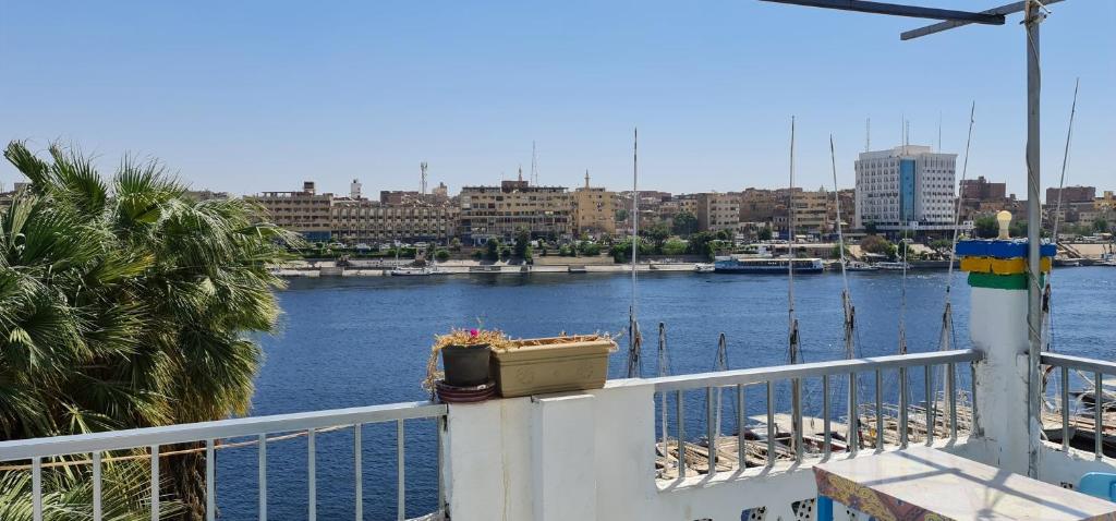a balcony with a view of a river and a city at Nuba Tod Abouda Guest House in Aswan