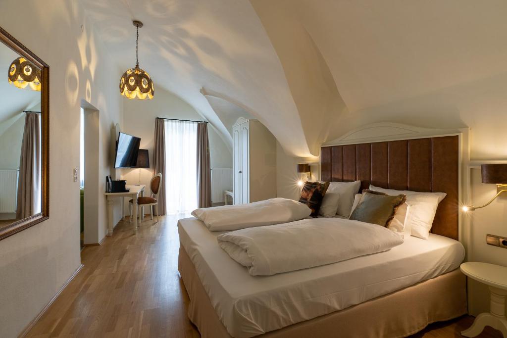 a bedroom with two beds in a room at Amedia Plaza Wels, Trademark Collection by Wyndham in Wels