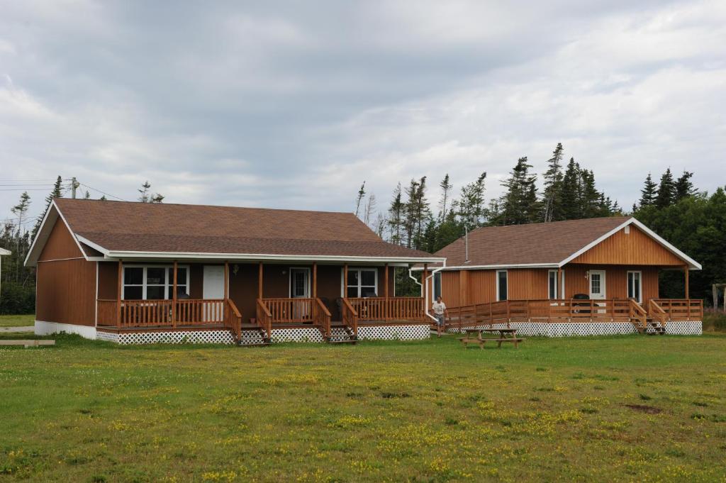 a house with a large yard in front of it at Riverside Chalets in River of Ponds