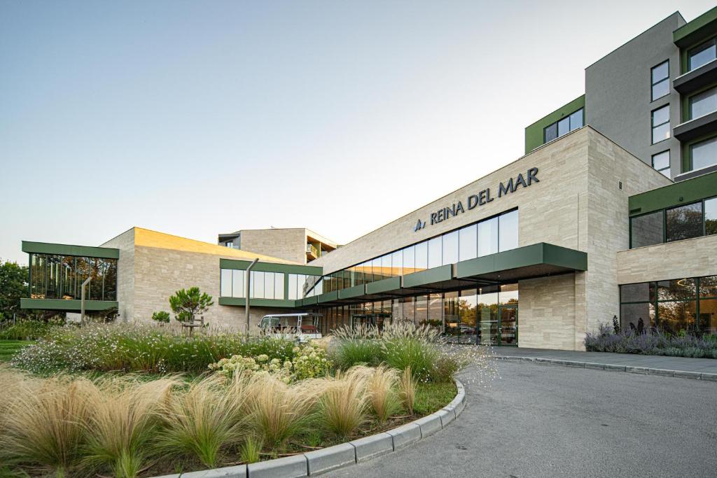 a building with a sign on the front of it at HVD Reina del Mar - Premium Spa Service & Free Parking in Obzor