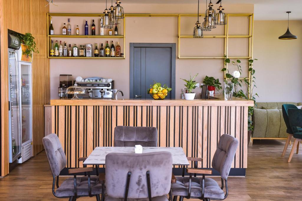 a dining room with a table and chairs at Airport Garden Hotel in Rinas