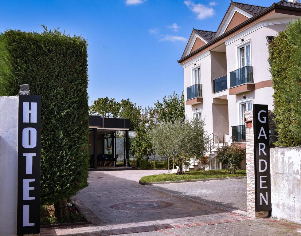 a building with a sign in front of it at Airport Garden Hotel in Rinas