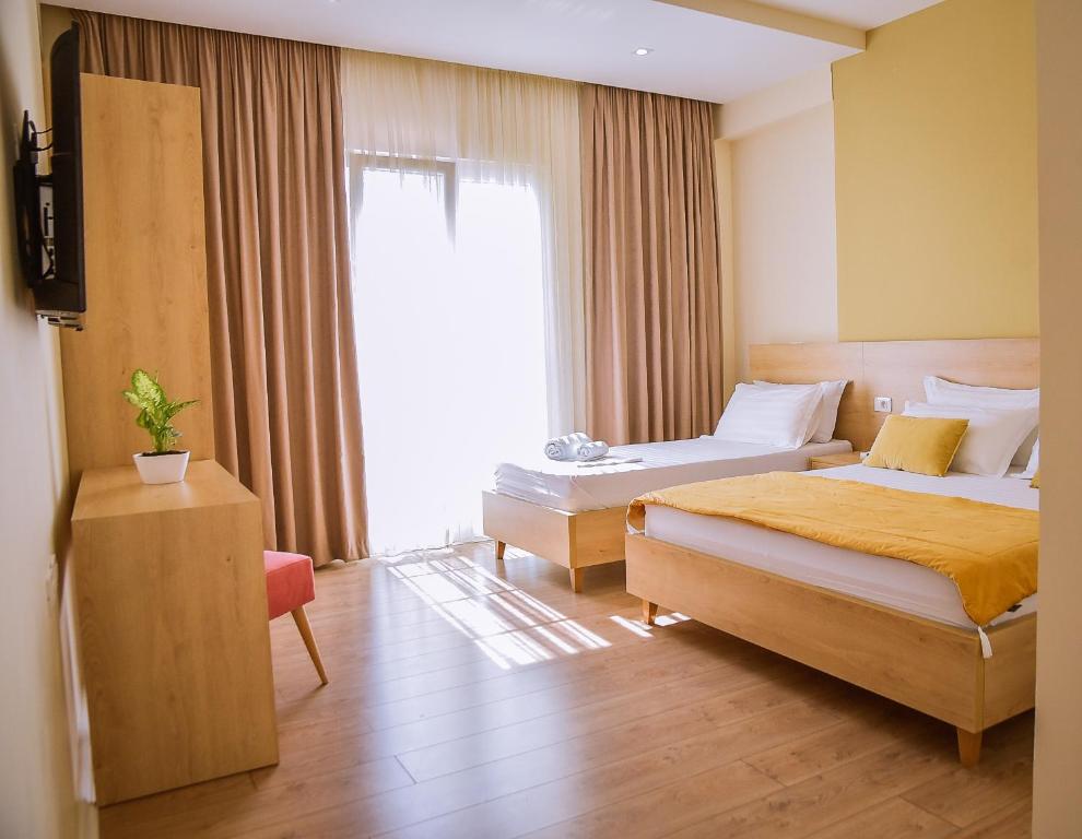 a hotel room with two beds and a window at Airport Garden Hotel in Rinas