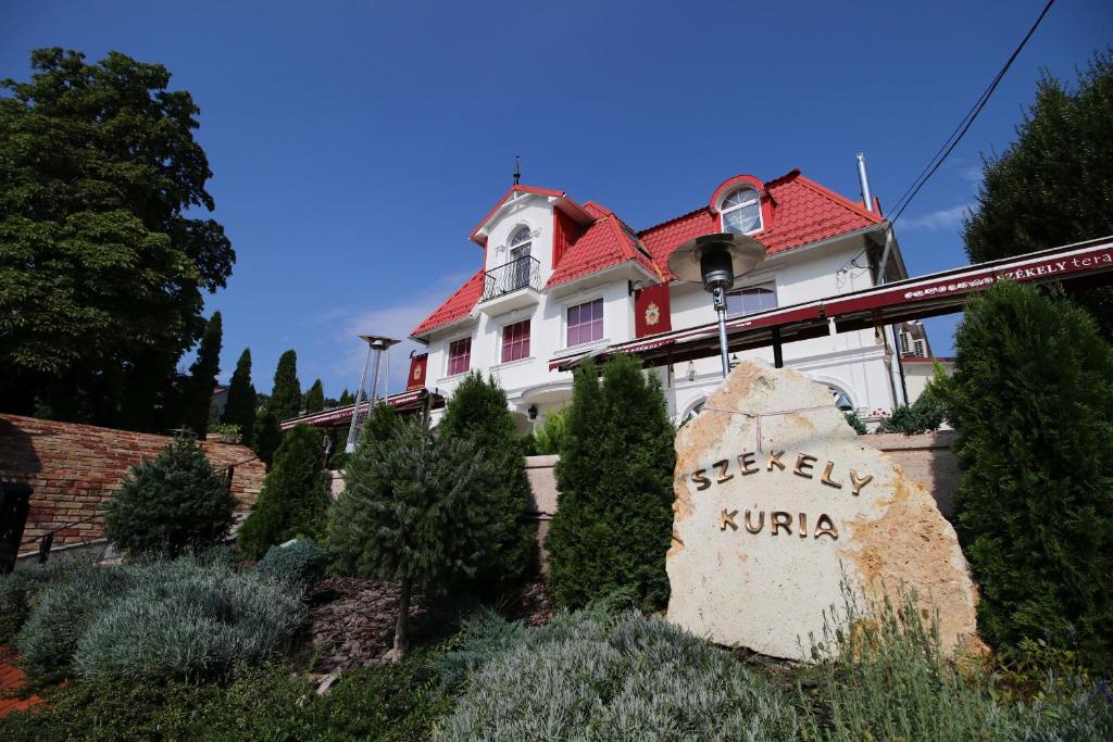 a large white house with a red roof at Székely Kúria in Miskolctapolca