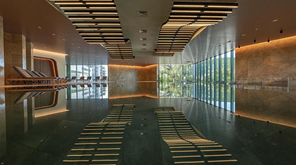 a lobby with a row of seats in a building at HVD Reina del Mar - Premium Spa Service & Free Parking in Obzor