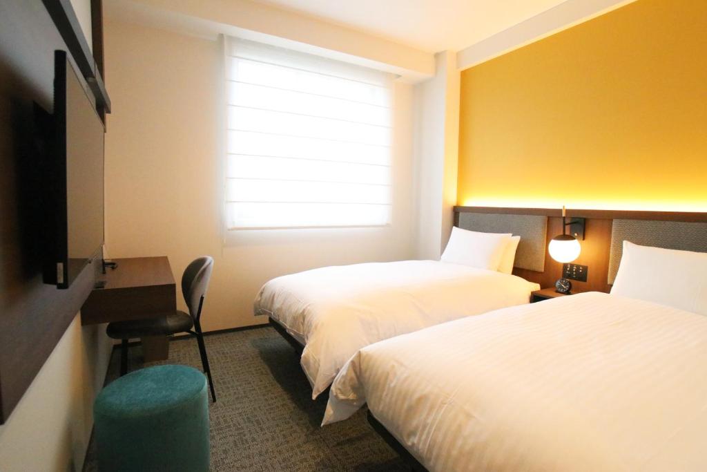 Postel nebo postele na pokoji v ubytování Hotel The M's Kyoto