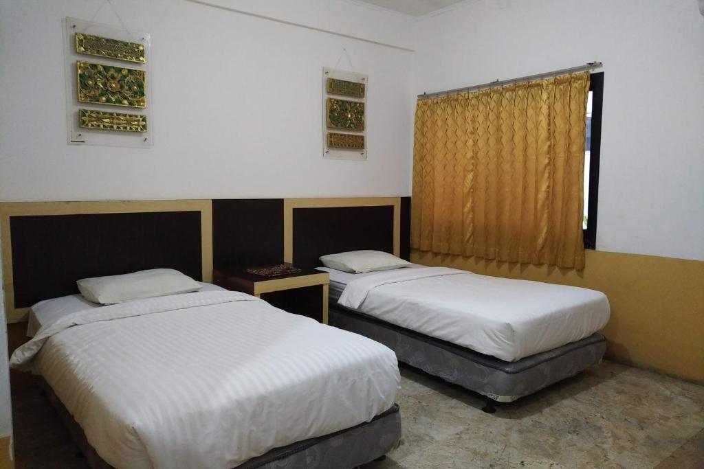 Postel nebo postele na pokoji v ubytování Hotel Syariah Cordova