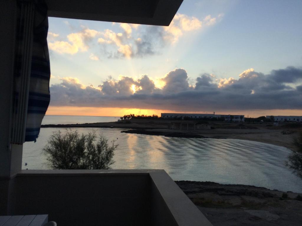 a view of a sunset from the balcony of a house at OSTUNIRESIDENCE baia camerini in Villanova di Ostuni