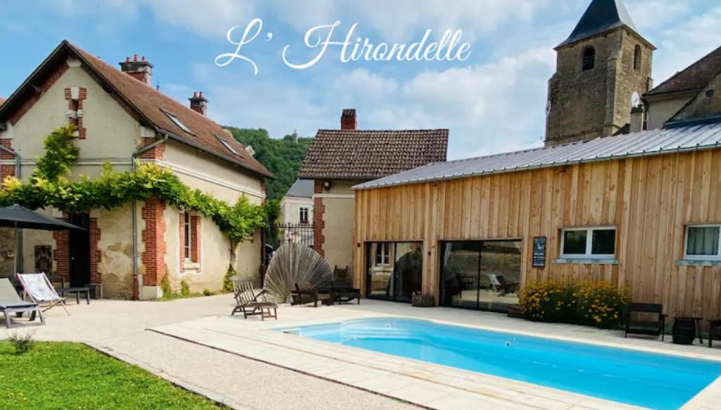 a house with a swimming pool next to a building at Pool house-L'hirondelle de Sermizelles- grand jardin, calme et nature aux portes du Morvan in Sermizelles