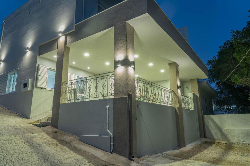 a building with a balcony on the side of it at Tzortzi's Family Apartments in Kaloi Limenes