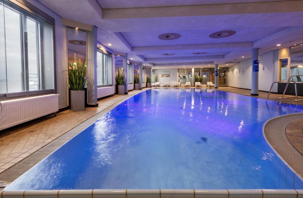 uma grande piscina com água azul num quarto de hotel em Maritim Hotel Frankfurt em Frankfurt am Main