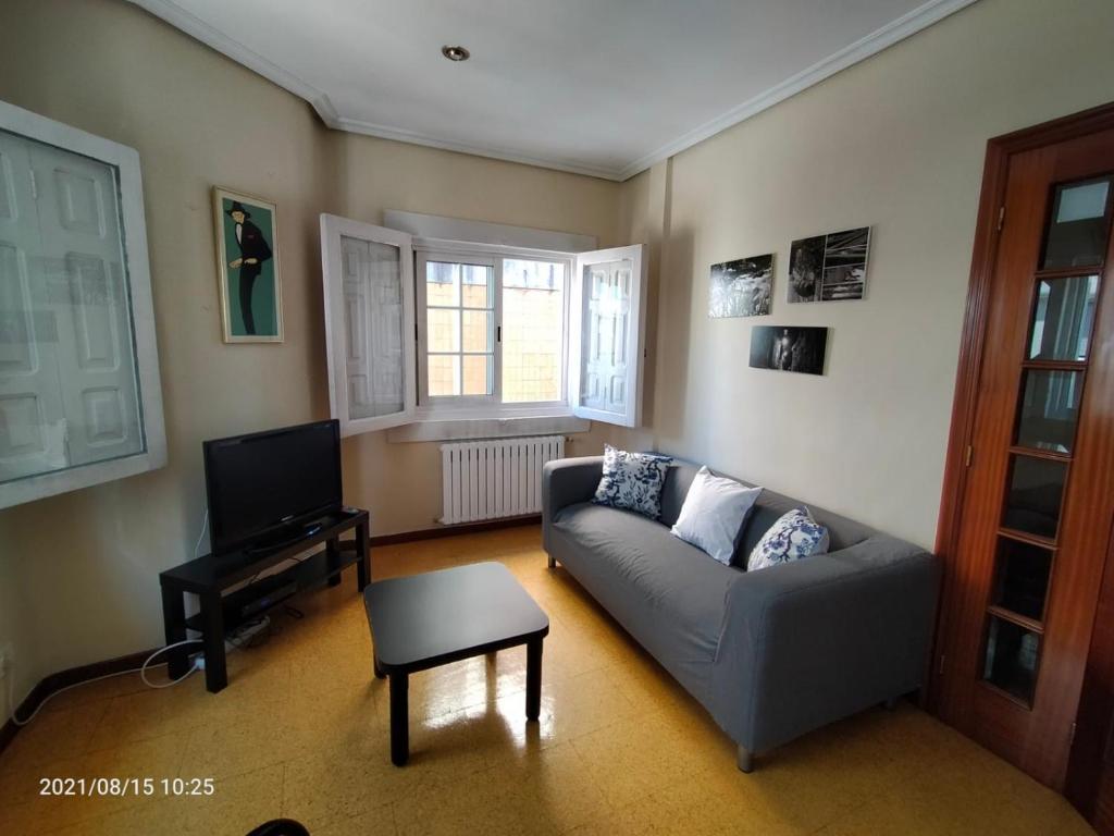 a living room with a couch and a tv at Casa Lolita / Camino de Santiago / Porriño in Porriño