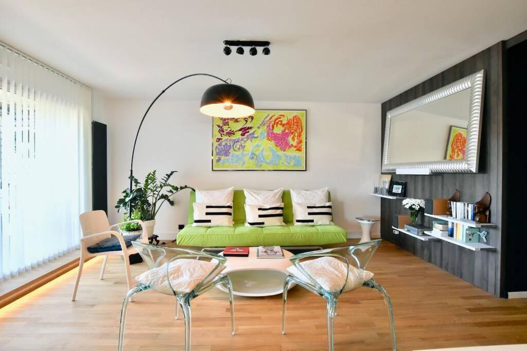 a living room with a green couch and a table at West Side - Full river view - Spacious - de Luxe in Lyon