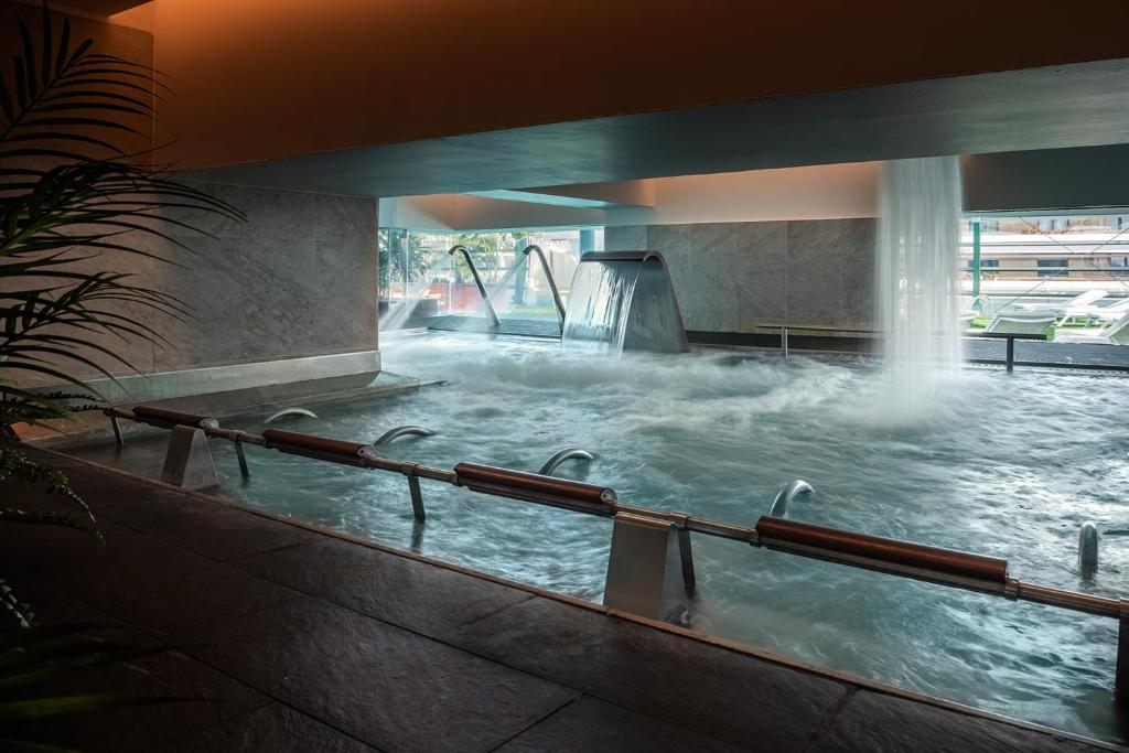 a large pool of water with a waterfall at Arrecife Gran Hotel & Spa in Arrecife