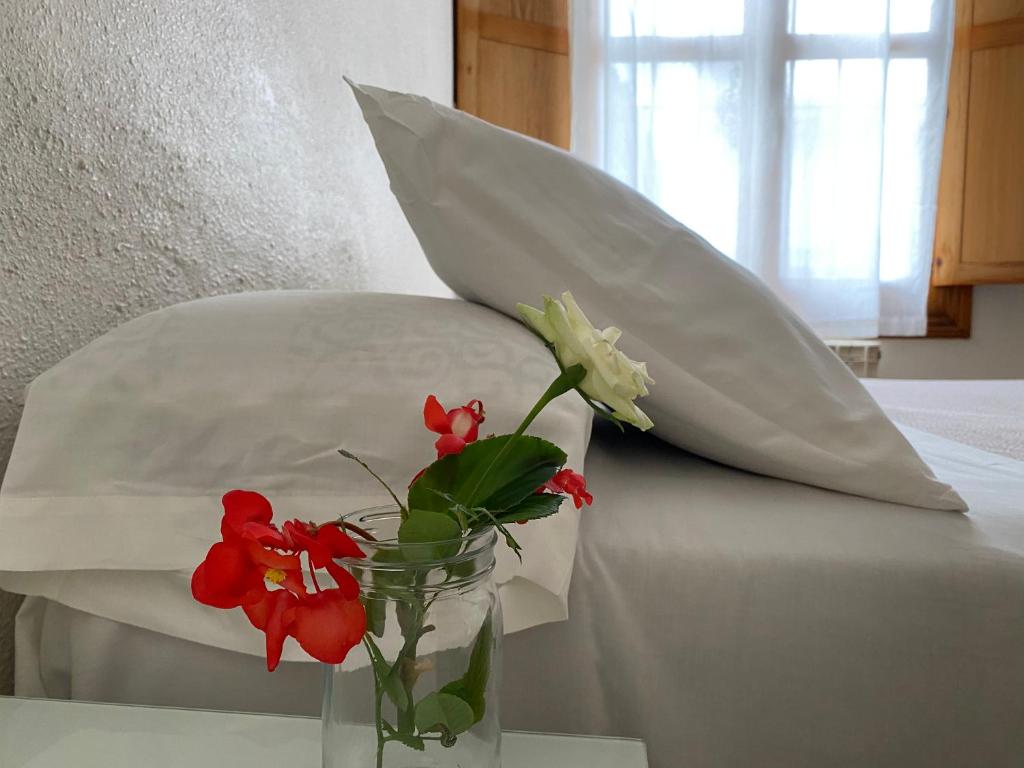 A bed or beds in a room at Hostal Moscatel