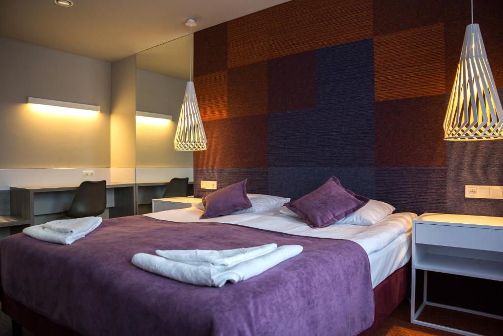 Postel nebo postele na pokoji v ubytování Hotel Quattro