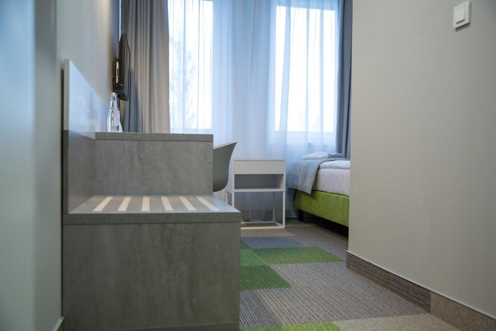 Postel nebo postele na pokoji v ubytování Hotel Quattro