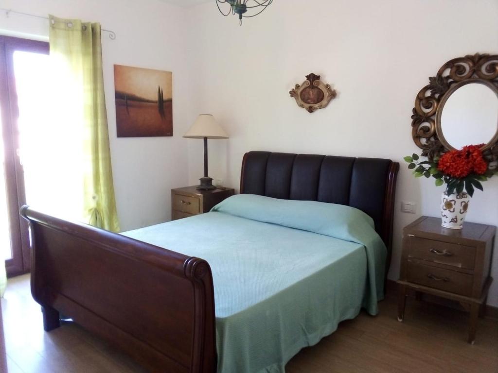a bedroom with a bed and a mirror on the wall at Stunning 2 Bed Apartment, Outside Terrace, Sleeps 4 in Villa Latina