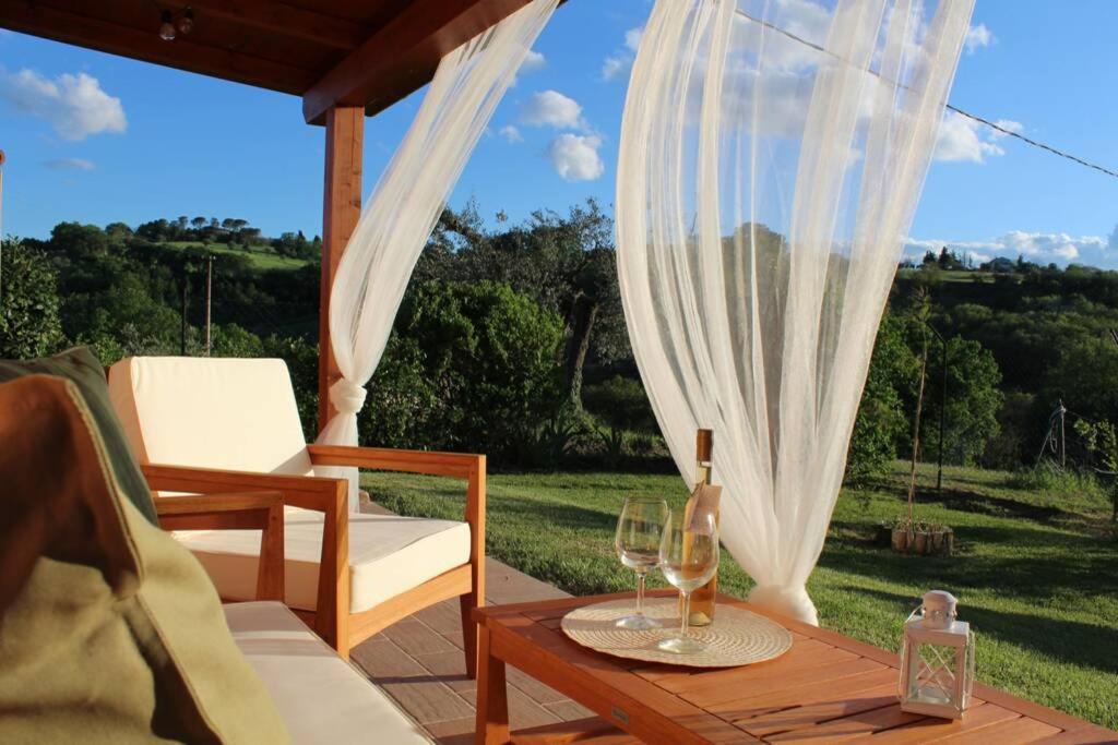une terrasse avec une table et des verres à vin. dans l'établissement Casa Kikenda, viaggio nella Natura, à Treia