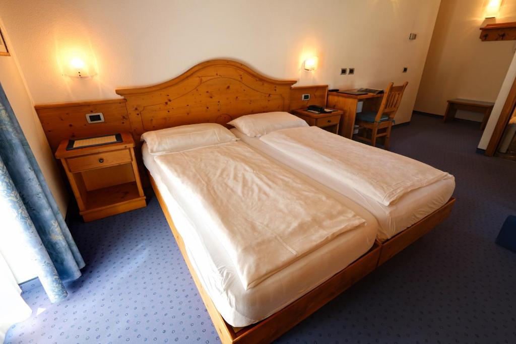 Postel nebo postele na pokoji v ubytování Hotel Garni Sottobosco
