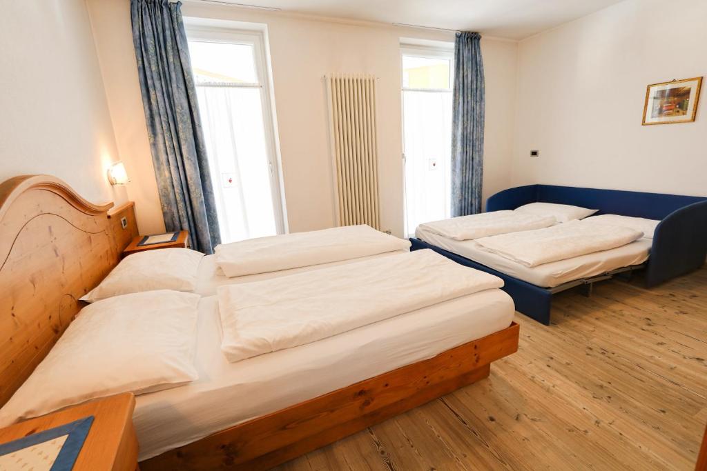 Postel nebo postele na pokoji v ubytování Hotel Garni Sottobosco