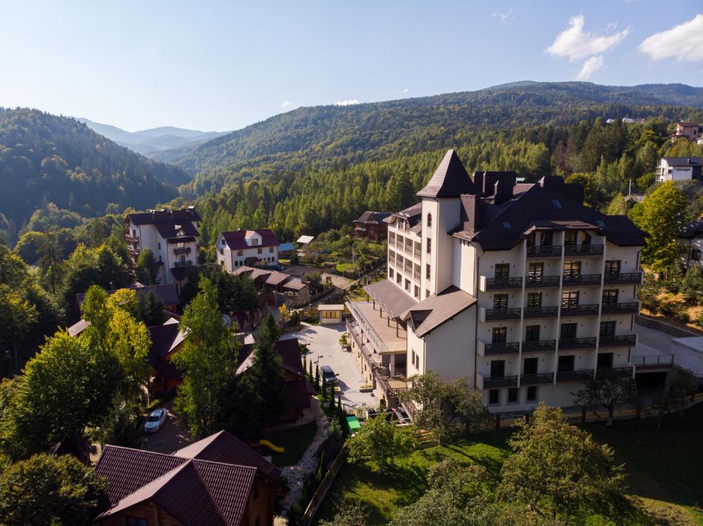 an aerial view of a town with mountains in the background at Ведмежа гора Panorama Spa Resort in Yaremche
