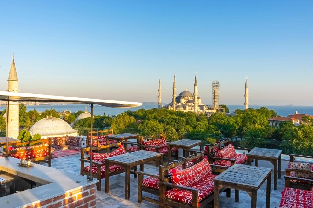 a patio with tables and chairs and a view of a mosque at World Heritage Center Hotel in Istanbul