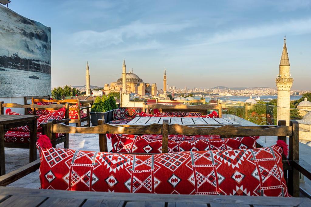 a group of red pillows on a balcony with a view of the city at World Heritage Center Hotel in Istanbul